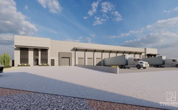 Amplio almacén logístico industrial con muelles de carga en un parque empresarial moderno, ideal para negocios de transporte y distribución.