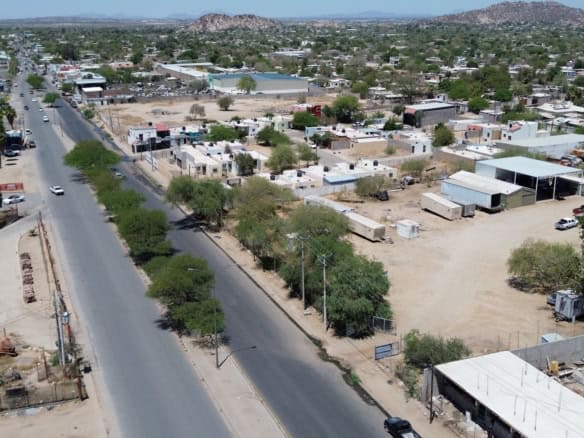 Amplia vista aérea de bienes raíces comerciales en zona urbana, con espacios de almacenamiento y construcción, ideal para inversión en bienes raíces comerciales en ubicaciones estratégicas.