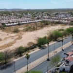 Terreno comercial ubicado en una zona en desarrollo con potencial para inversión inmobiliaria, rodeado de viviendas y accesos principales, ideal para proyectos de bienes raíces comerciales.